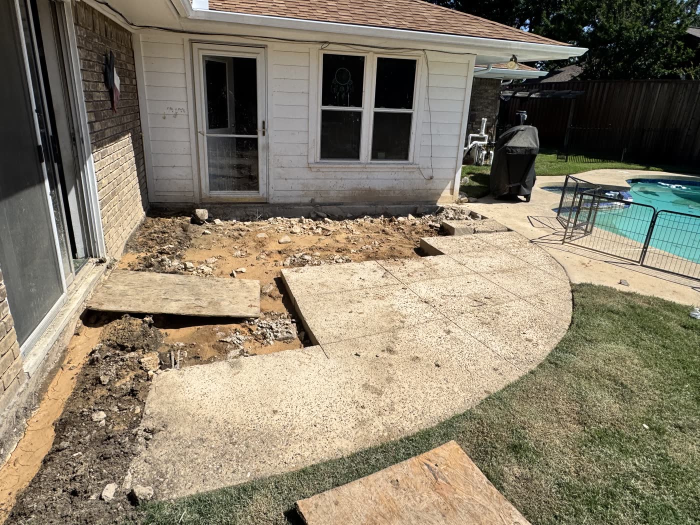Excavated poolside patio before new concrete and drainage work